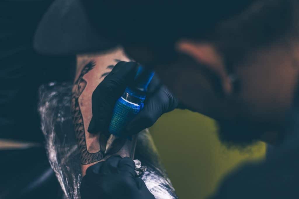 Artiste tatouer en pleine séance de tatouage